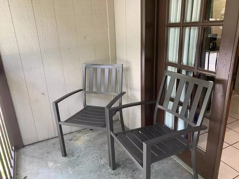 Two chairs on balcony of double queen courtside room